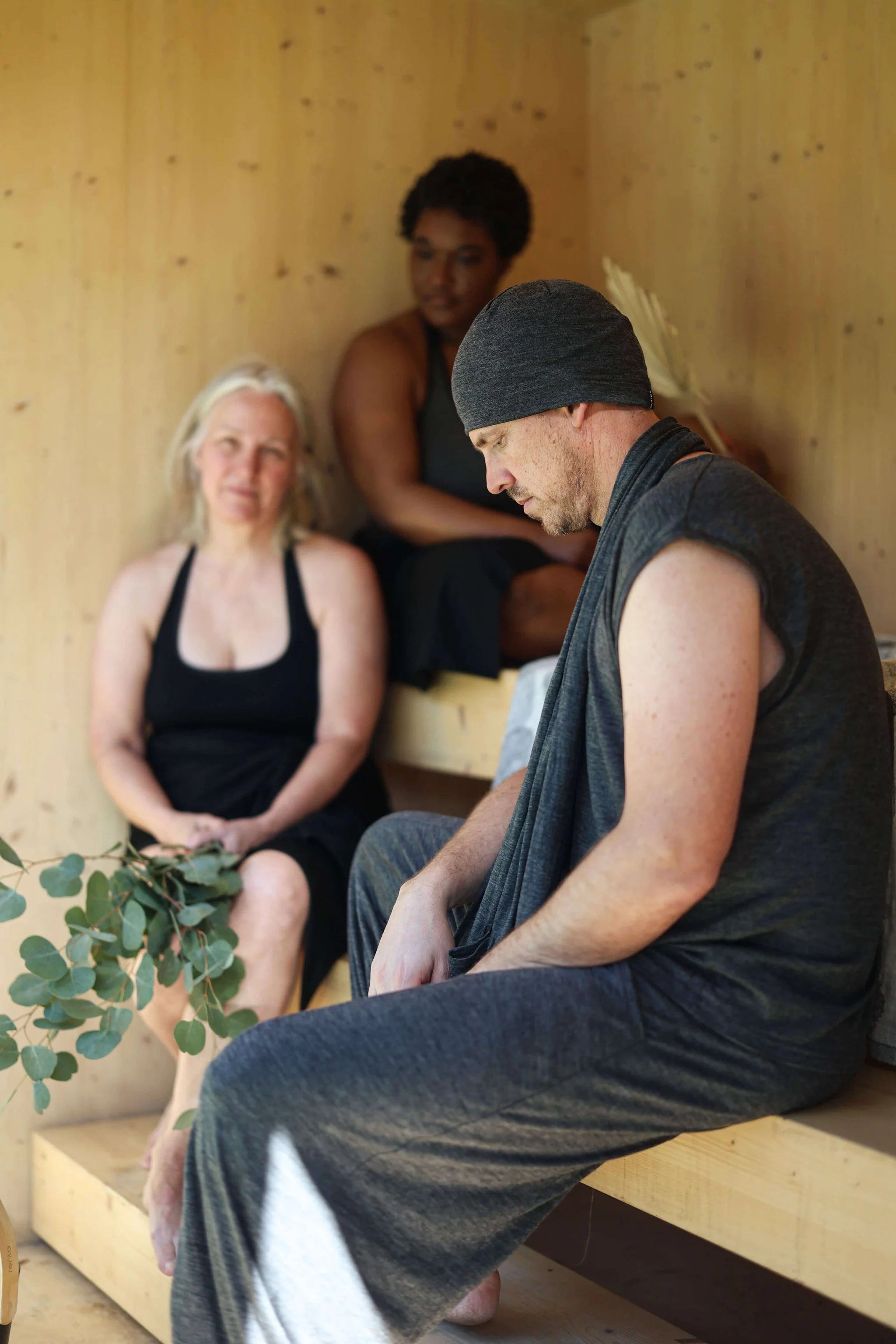 Merino wool pocket wrap worn during a sauna recovery ritual, providing lightweight warmth and breathable comfort.