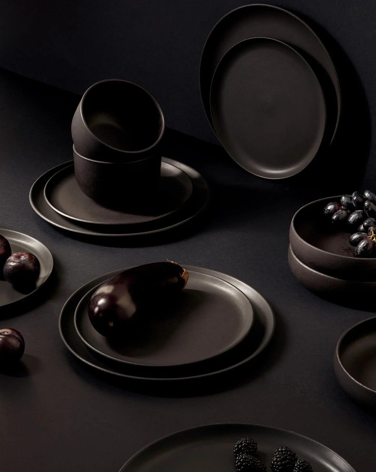 Stoneware bowl in Matte Black styled overhead with dinnerware set