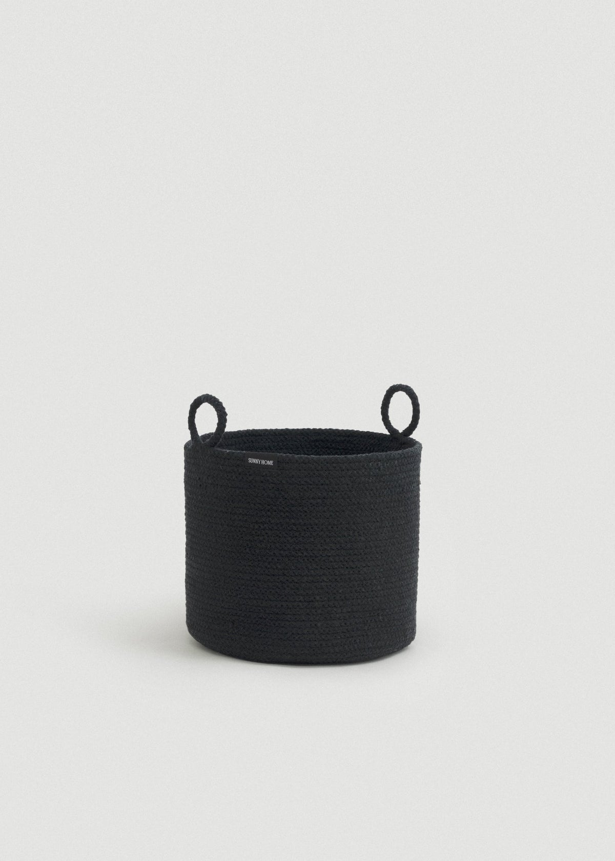 Tall black cotton rope storage basket with a cylindrical shape and two upright loop handles.