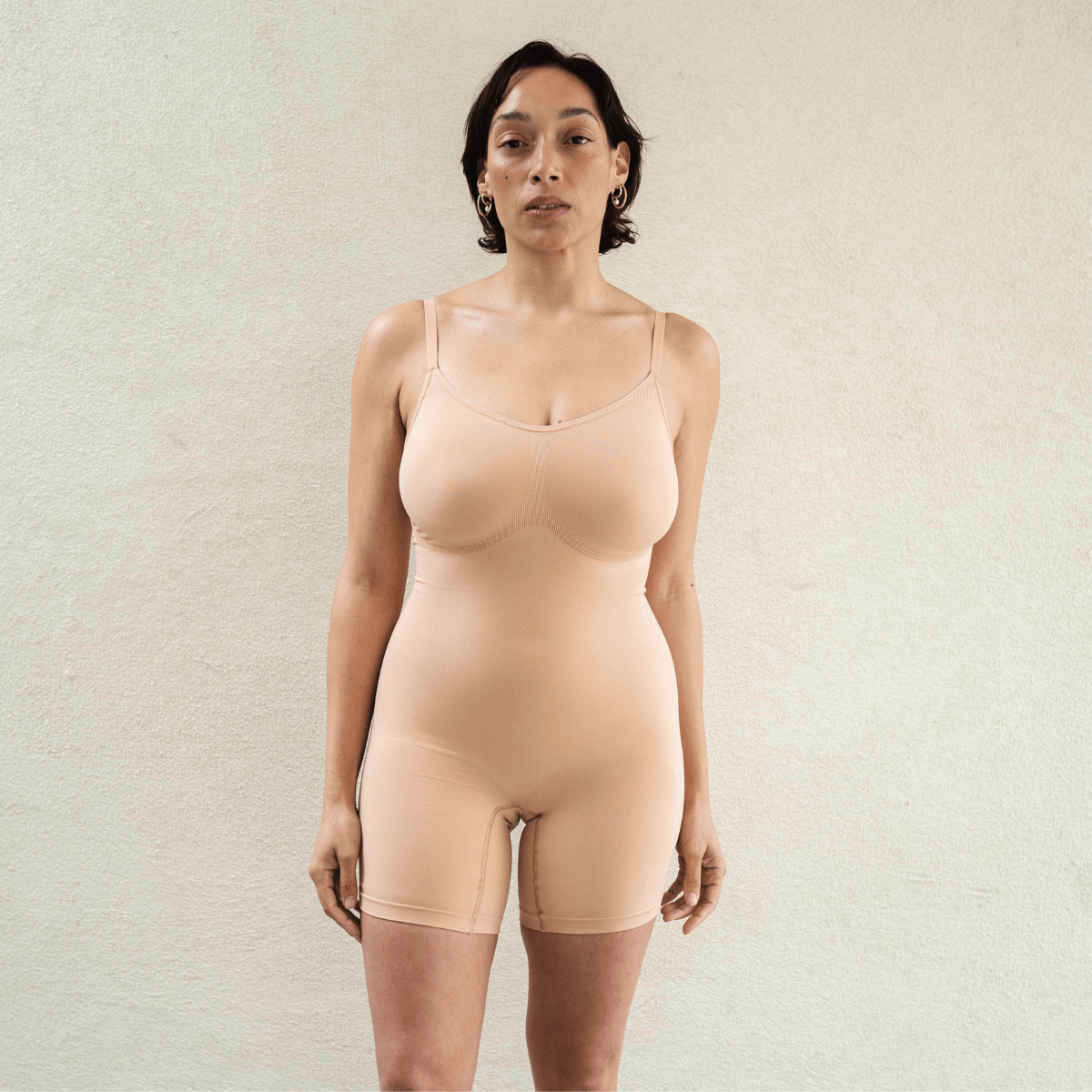 Front view of seamless shapewear bodysuit on model with natural fit and light sculpting support