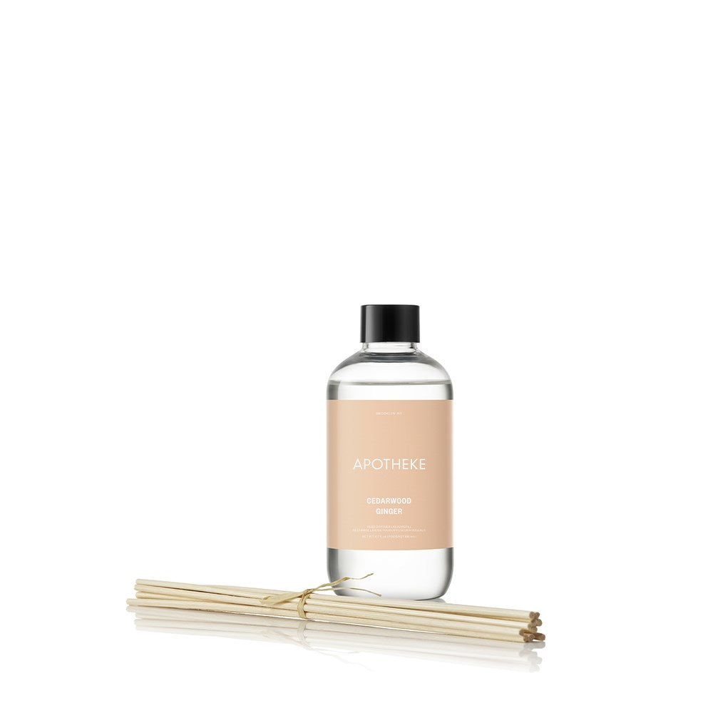 APOTHEKE Cedarwood Ginger Reed Diffuser Refill bottle with black cap and bundled natural rattan reed sticks