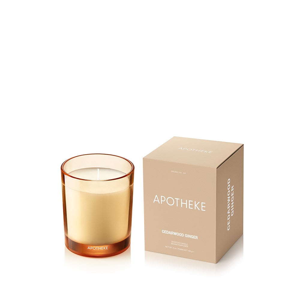 Cedarwood Ginger Petite Candle in amber sand-toned glass beside APOTHEKE packaging box