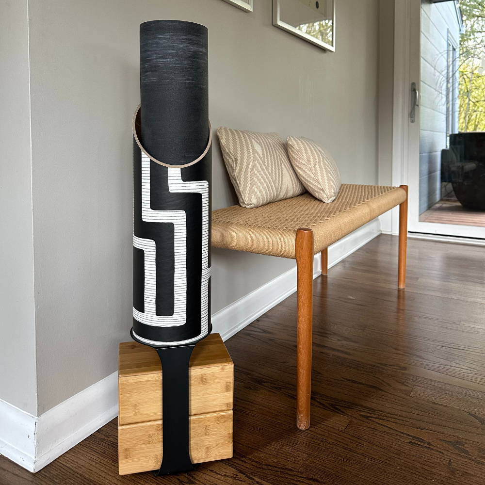 Full Colony tube and wooden block stand displayed beside a bench on a hardwood floor.