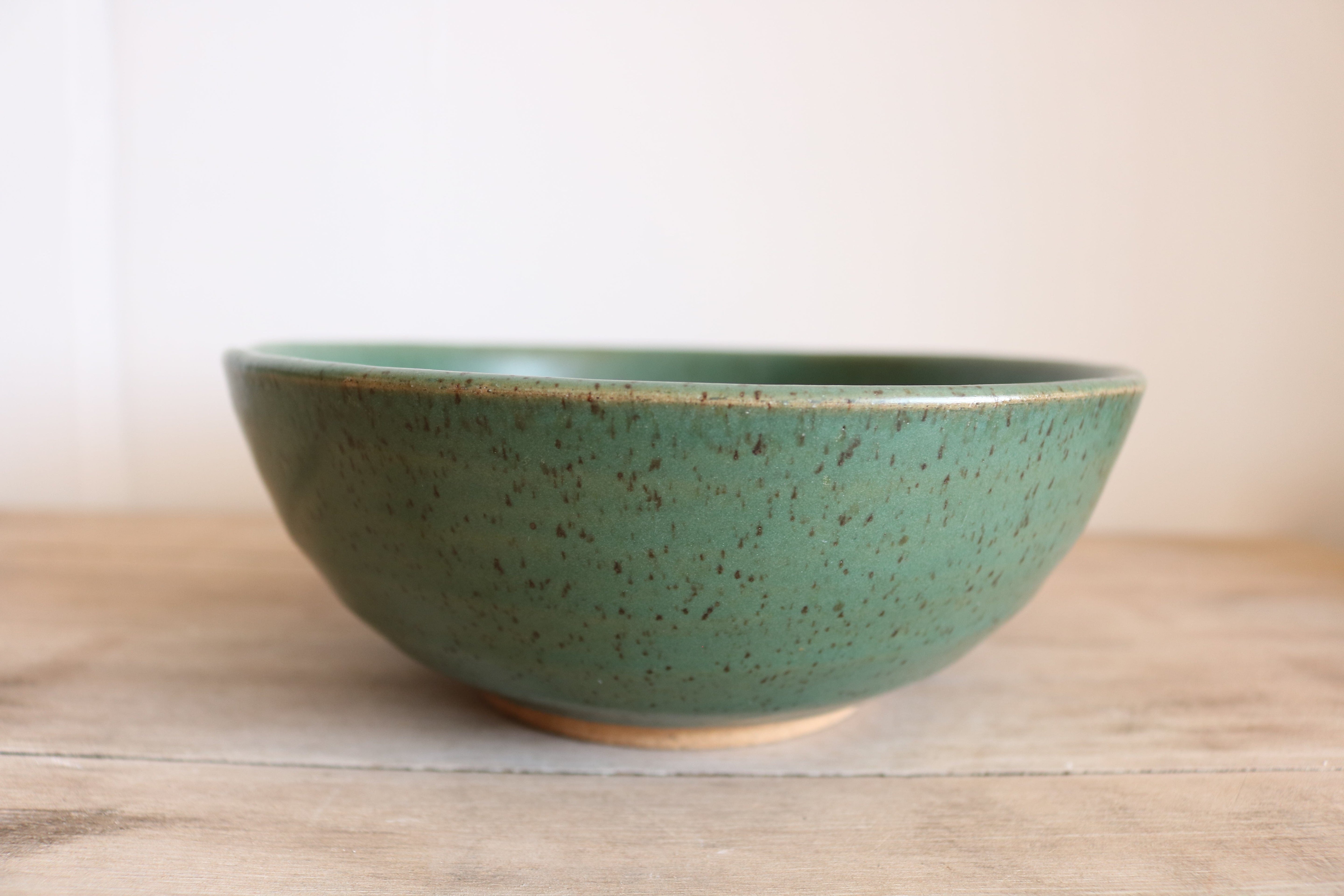 Green handmade ceramic cereal bowl side view