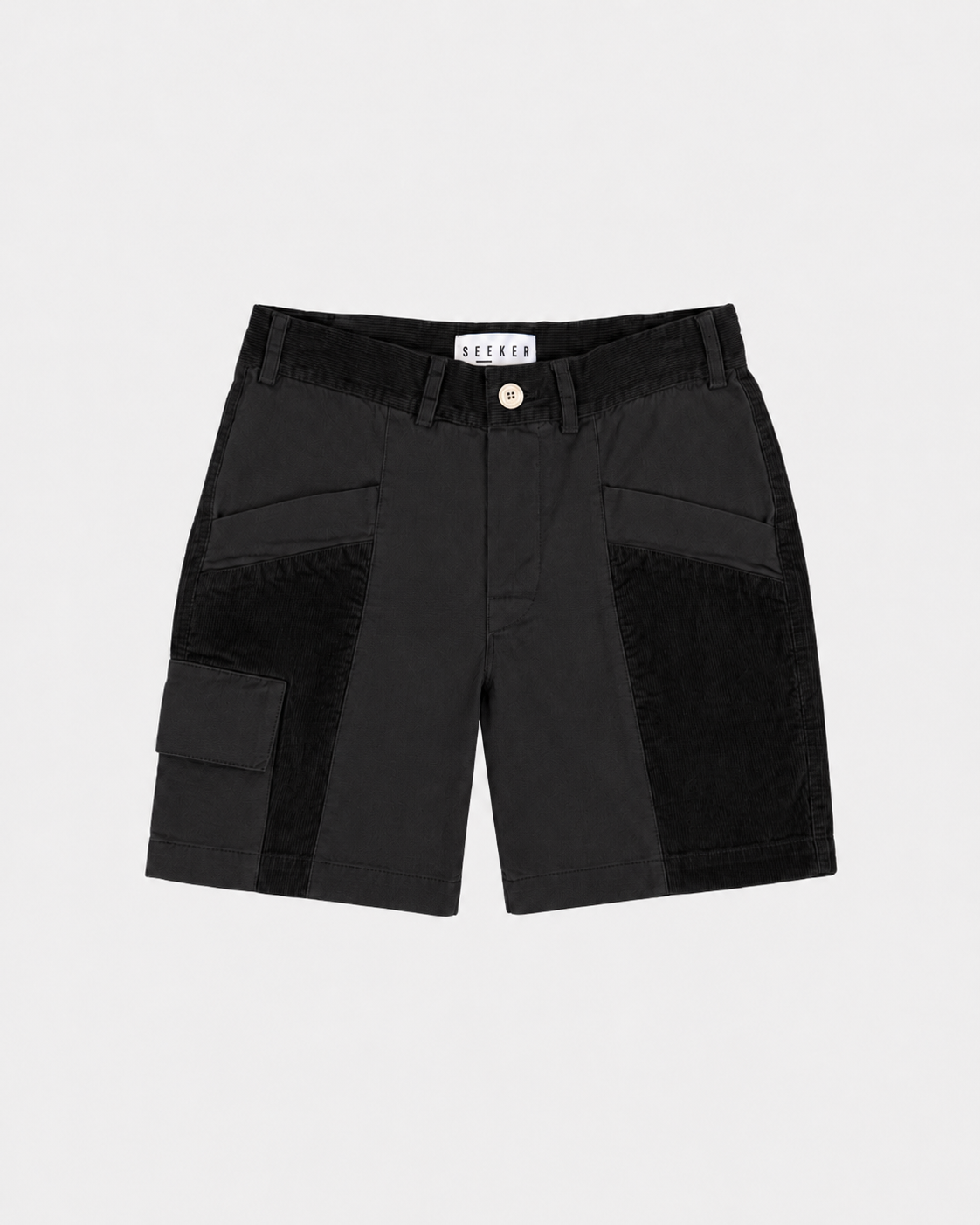 Front product view of black Trek Shorts with tonal panels and a buttoned cargo pocket.
