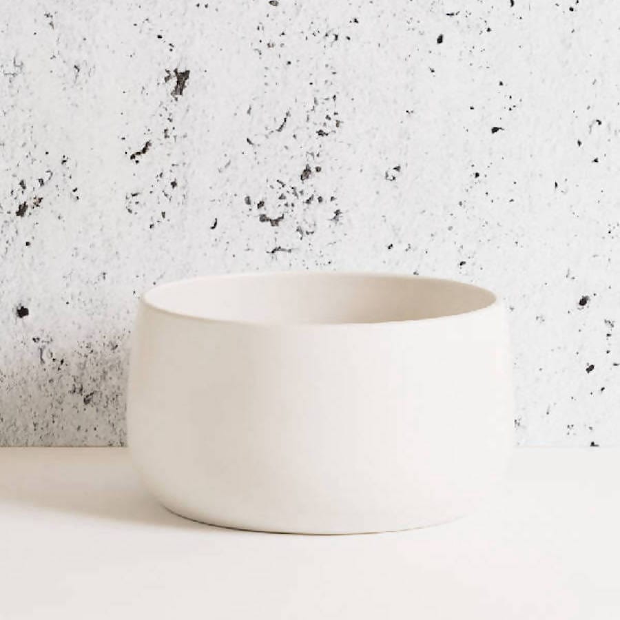Stoneware serving bowl 120 oz in Matte White against textured concrete background