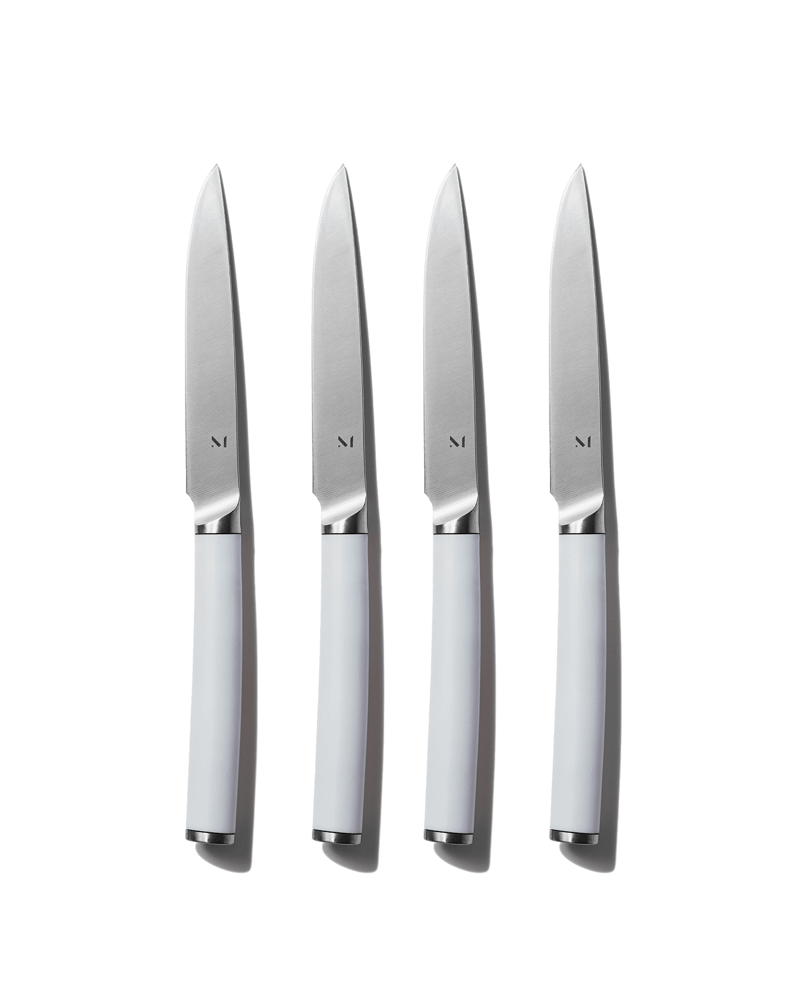 Material Kitchen Table Knives set of four in neutral finish on white background