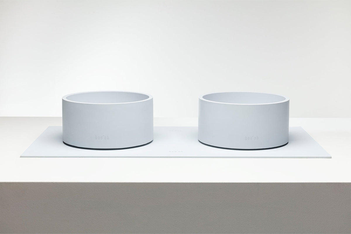 Two matching Mogo Bowls displayed side by side on a raised white platform.