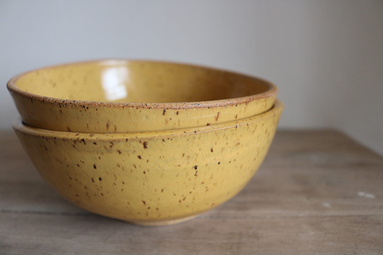 Mustard yellow handmade ceramic cereal bowl side view