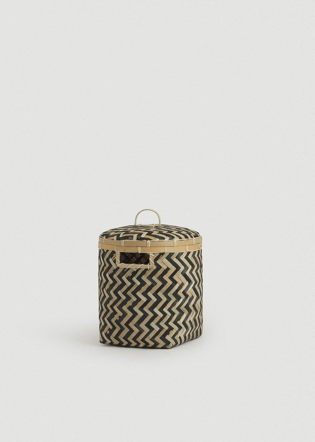 Front view of the Small Java basket showing its compact cylindrical shape and rectangular side opening.