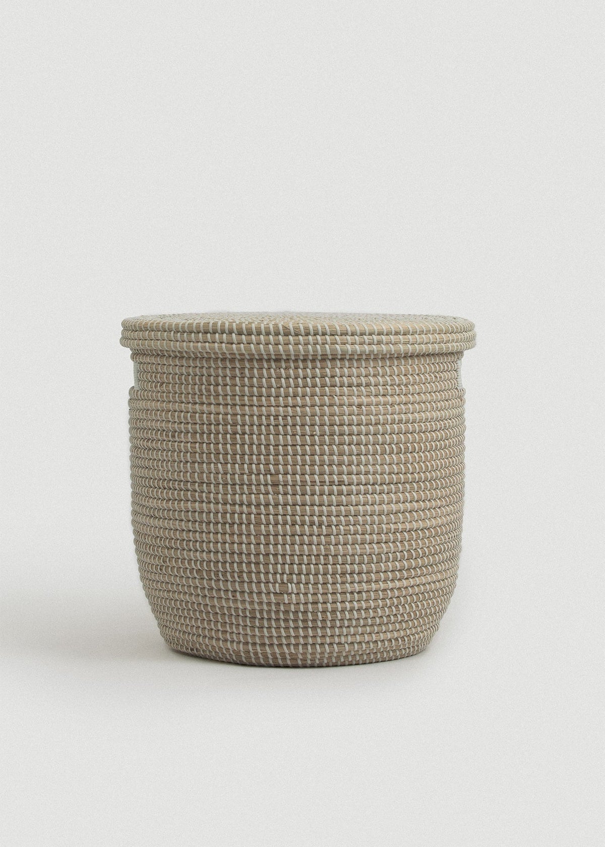 Front view of the lidded Medina basket showing its rounded cylindrical shape and tightly woven texture.