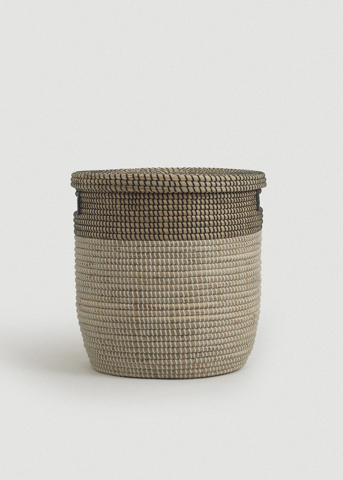 Front view of the Black Medina basket showing its rounded cylindrical shape and dark woven rim.