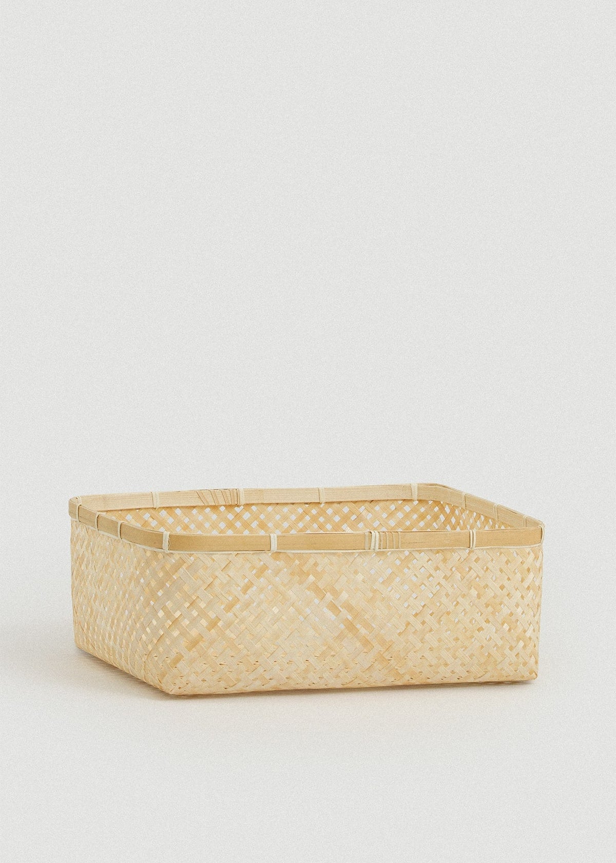 Medium rectangular basket with natural woven sides and a structured bamboo frame.