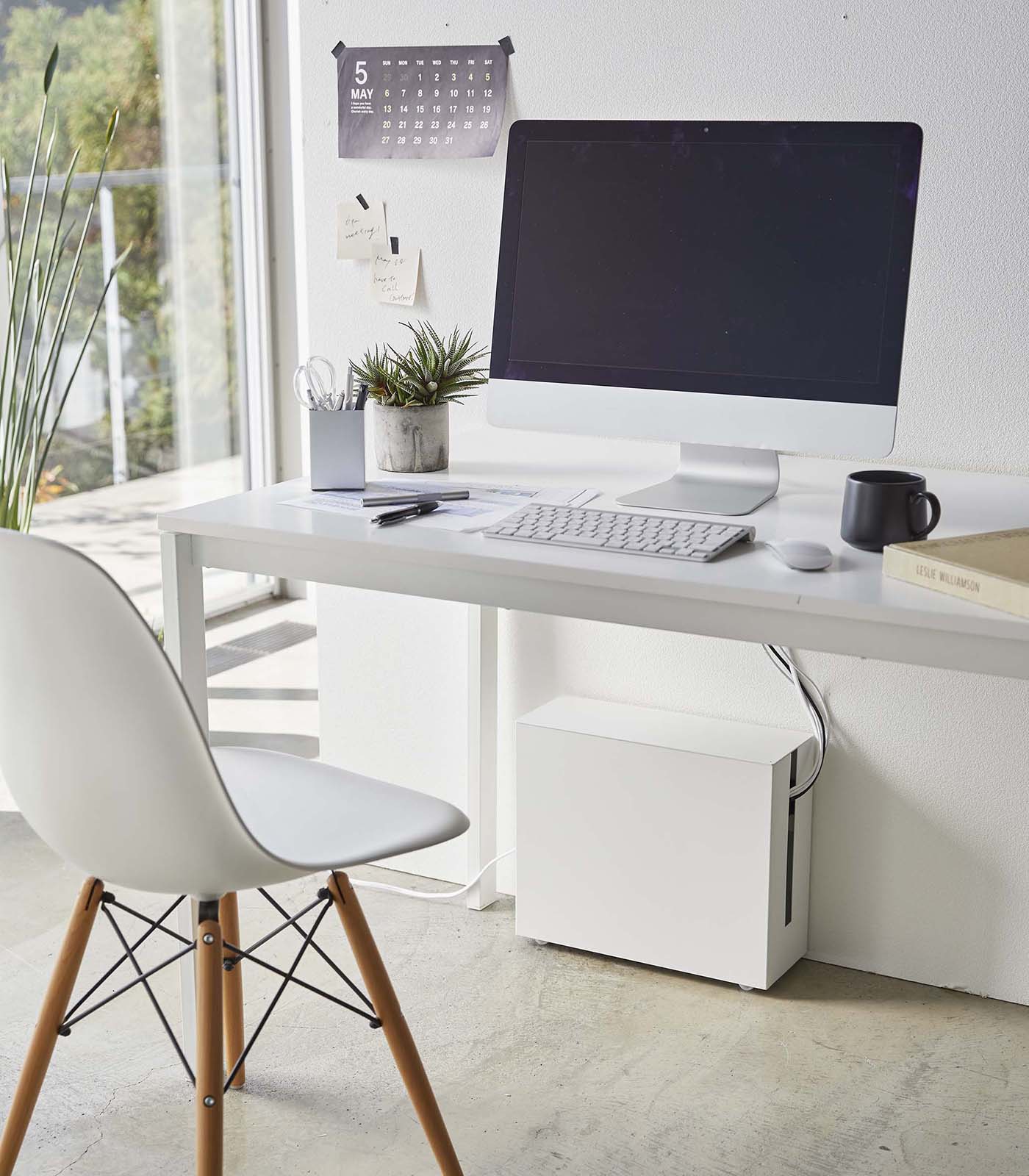Modern home office with a desk, computer, and chair.