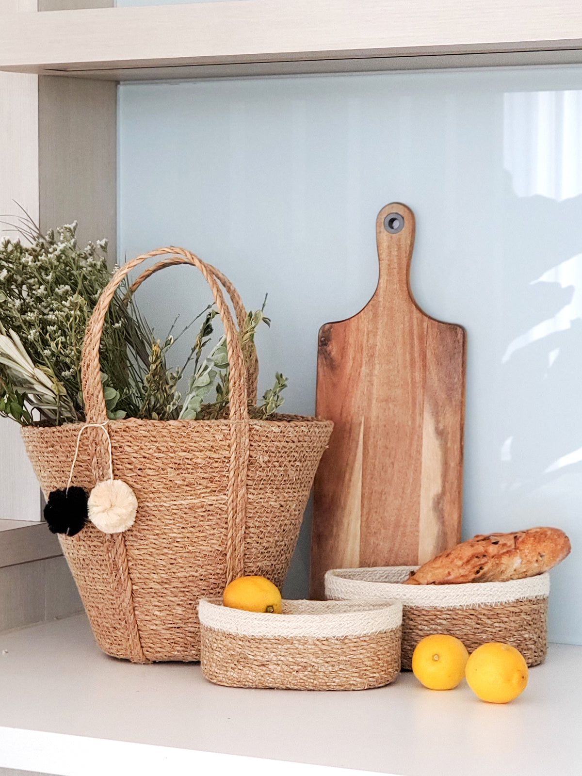 Korissa Savar Oval Bowl styled with woven tote basket and baguette bread