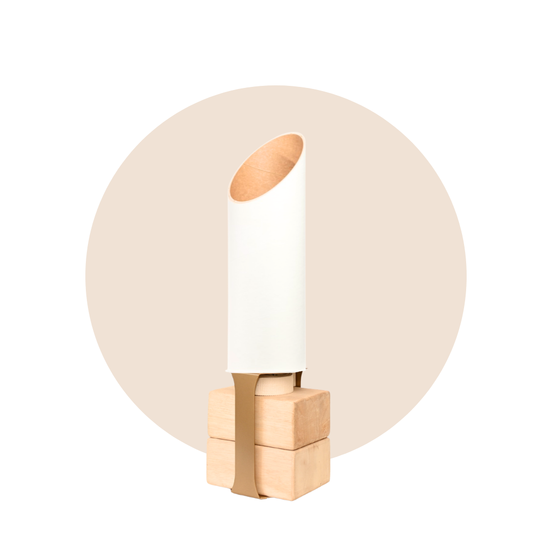 Full Sattva yoga mat tube and pale wood base displayed against a soft beige circular backdrop.
