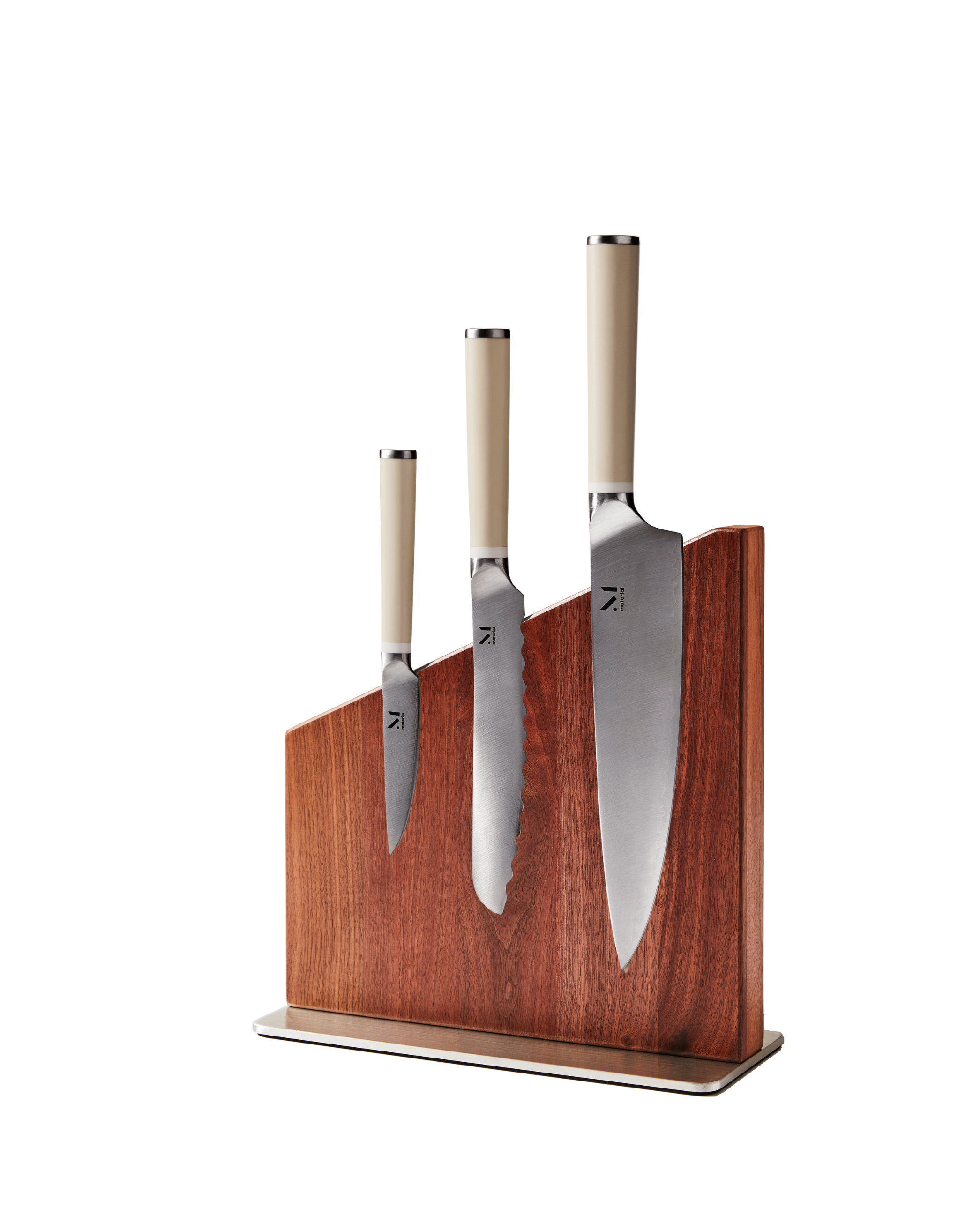 Three kitchen knives displayed in Material's magnetic wooden knife stand