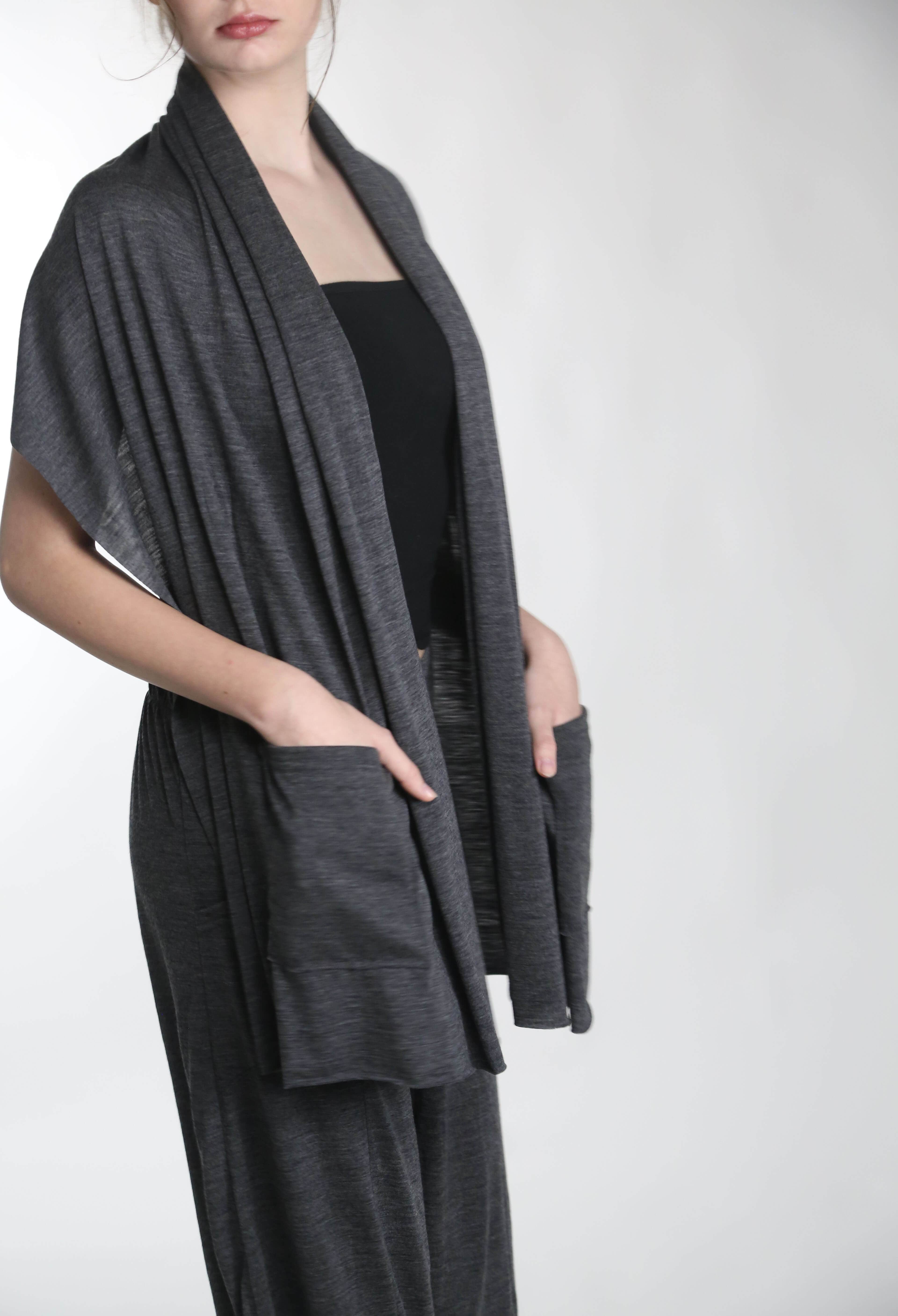 Merino wool pocket wrap worn as a shawl layer, combining warmth, breathability, and minimalist design.