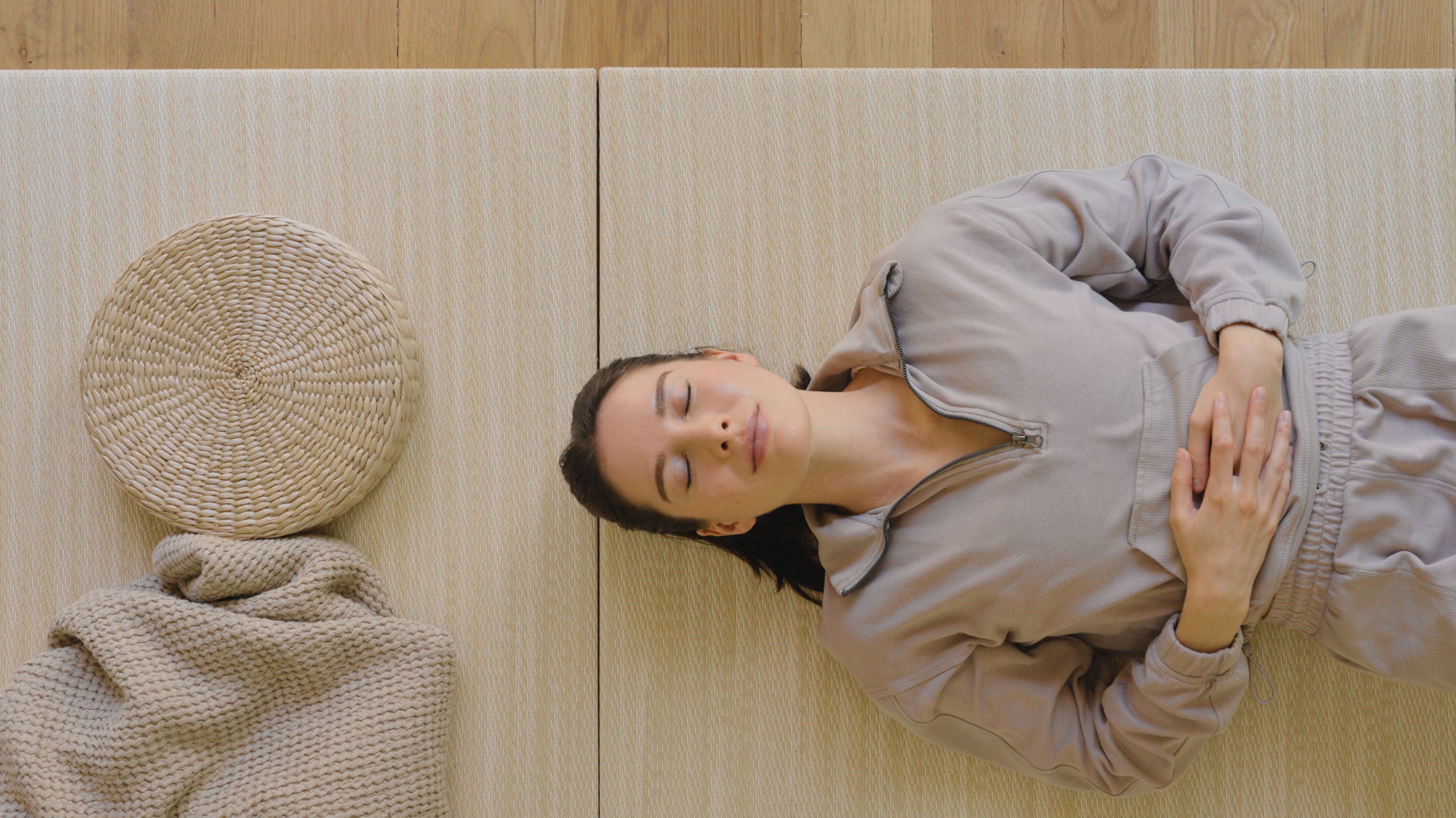Woman laying on Japandi Tatami Mats in bedroom