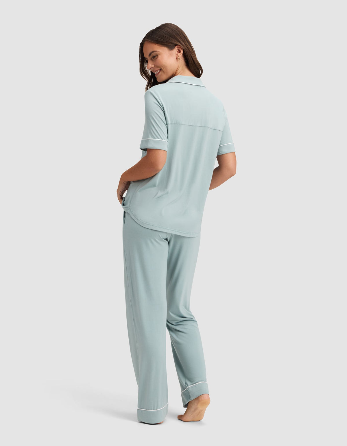 Back view of the pale blue pajama set, showing the top’s horizontal back seam, short sleeves, and loose full-length pants.