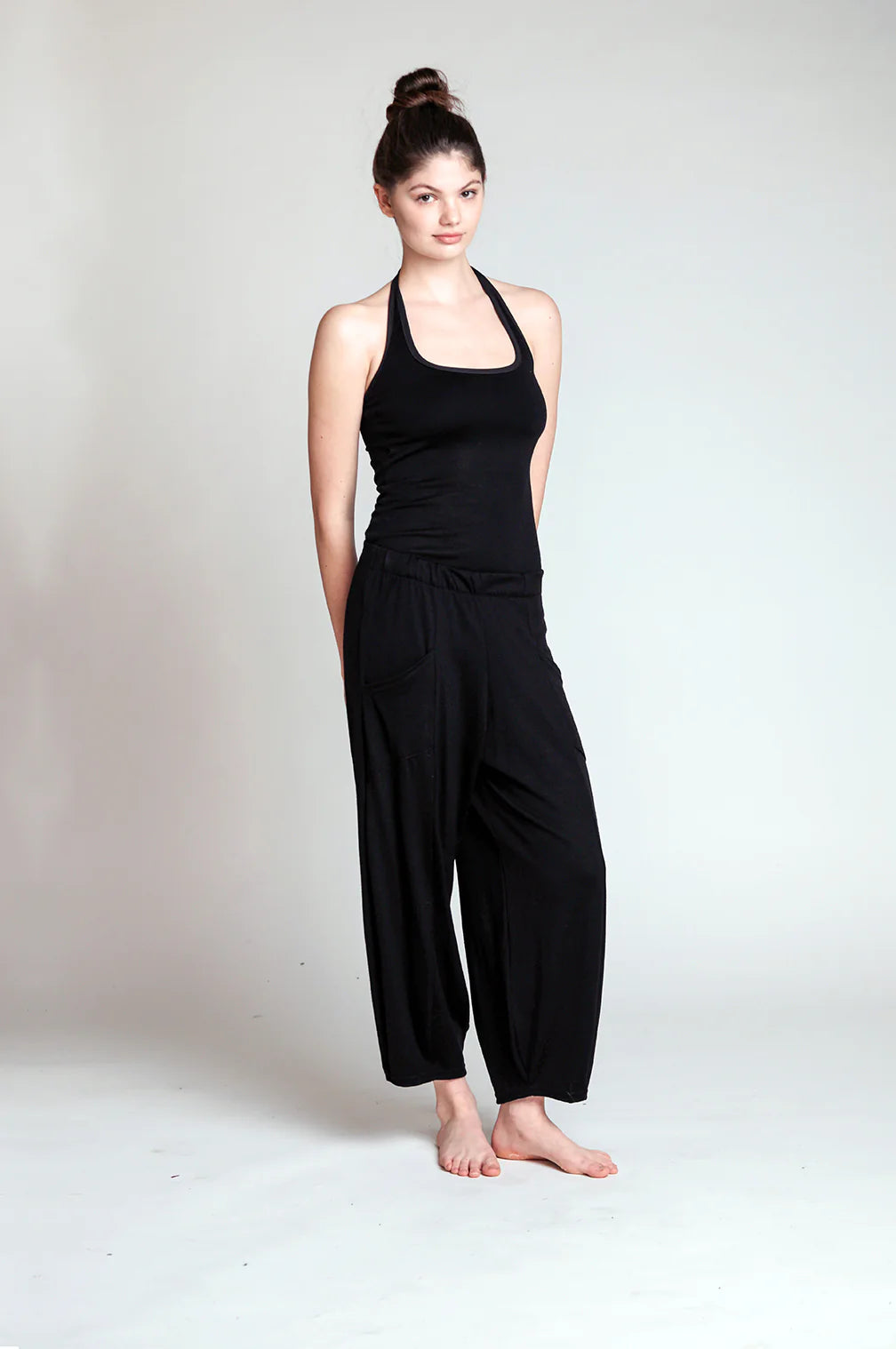 Woman wearing black merino wool lounge pants showcasing a relaxed fit, minimalist style, and natural temperature regulation.