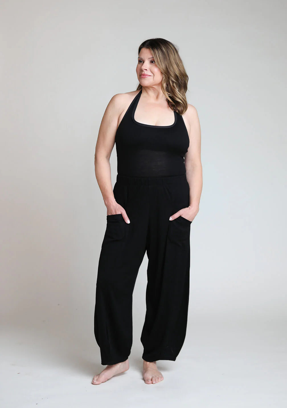 Full-length view of black merino wool lounge pants designed for lounging, recovery rituals, travel, and everyday wear.