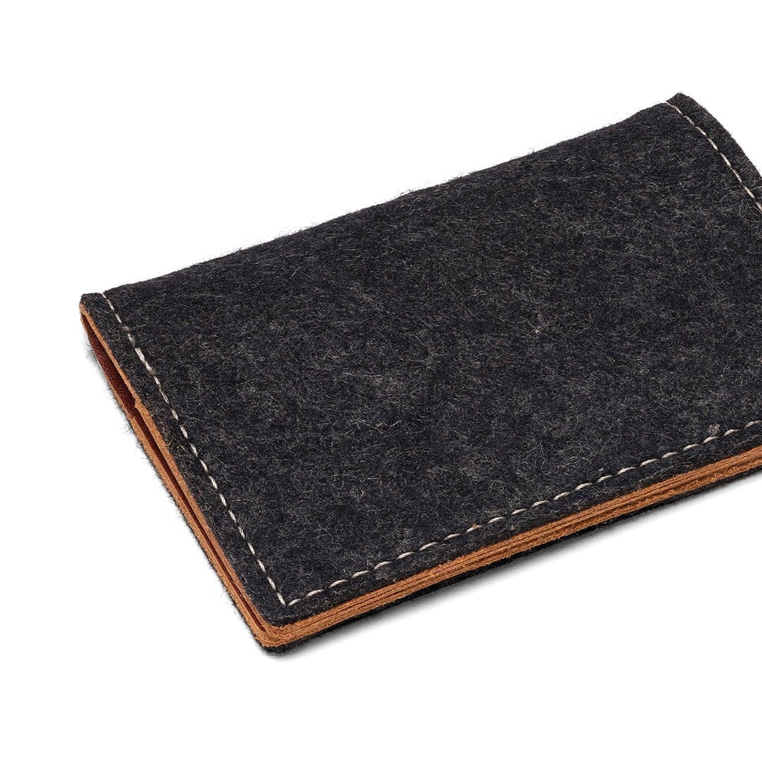 Charcoal wool felt bifold wallet with vegetable-tanned leather accents and durable construction