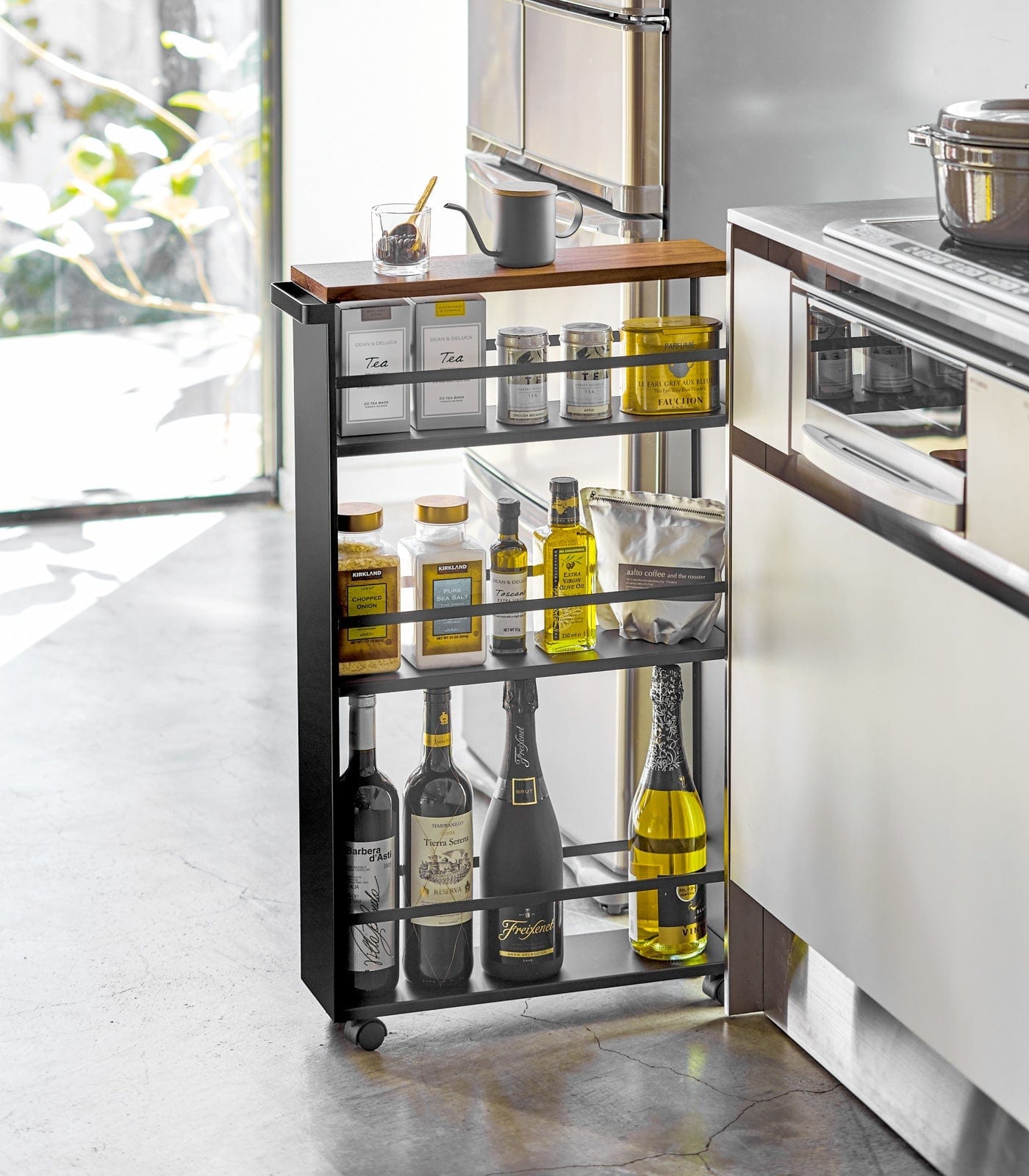 Kitchen cart with bottles and containers in a modern kitchen setting. Slim Storage Cart (32" H) - Steel