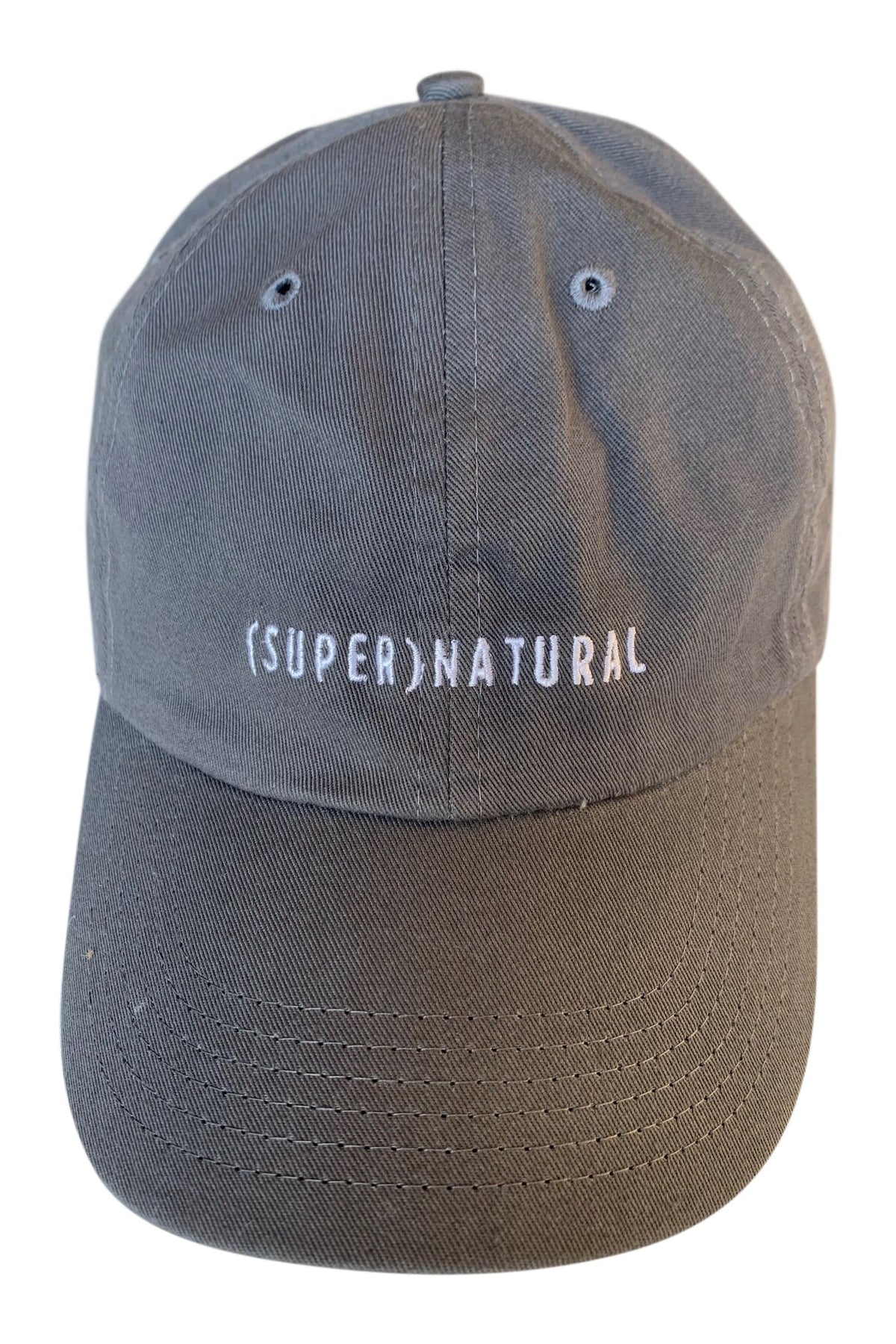 Front product view of a blue-gray SUPERNATURAL cap with a dark brown curved brim and white embroidered lettering.
