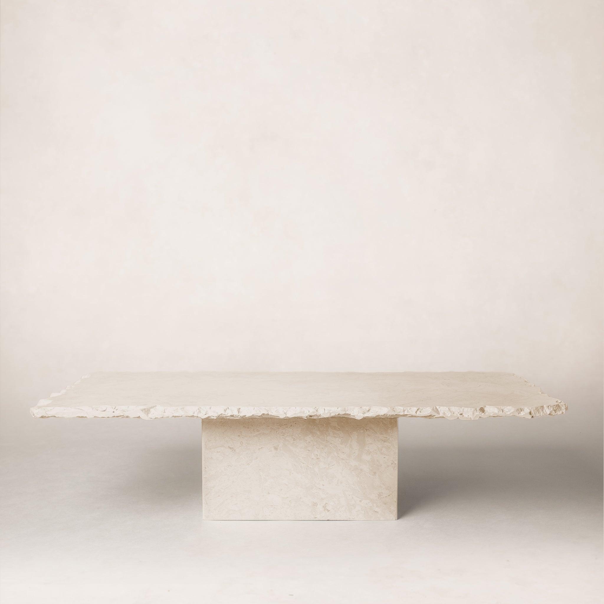 Sofita marble coffee table with minimal veining and sculptural pedestal base