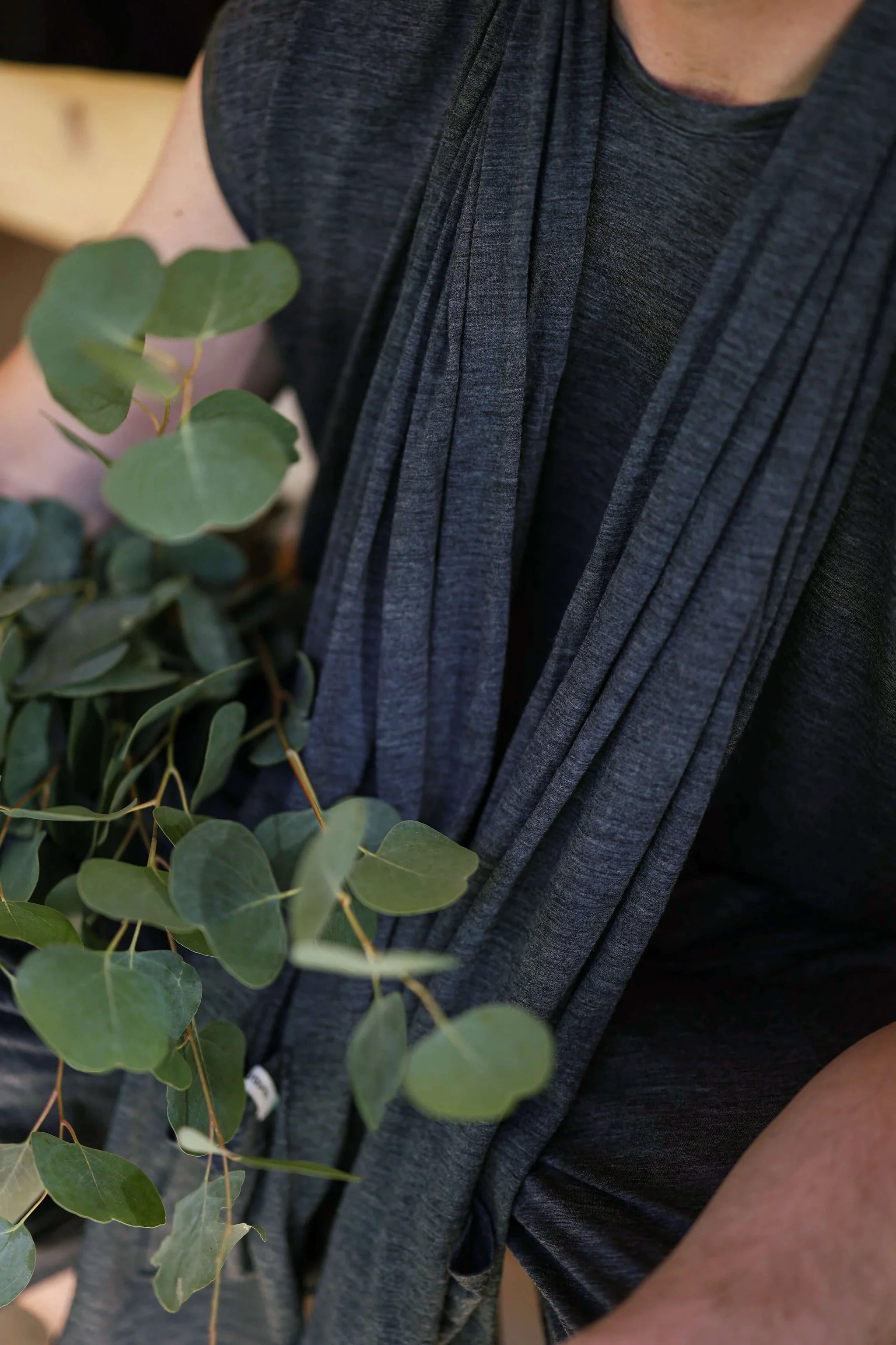 Close-up of charcoal merino wool pocket wrap fabric showing soft texture, natural drape, and timeless minimalist styling.