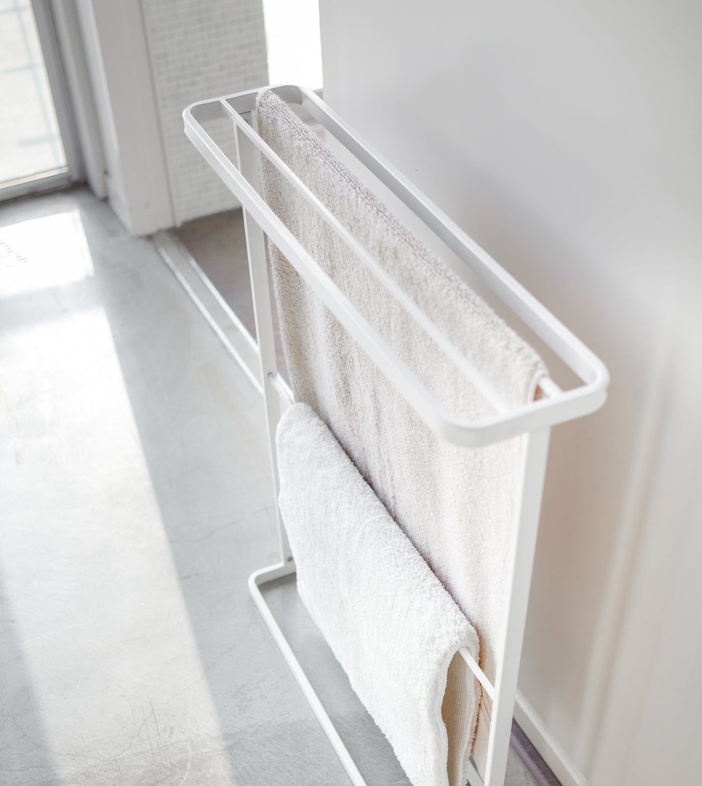 Towel rack with white towels in a bright room. Bath Towel Hanger (30" H) - Steel