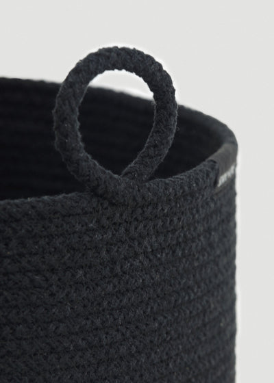 Close-up of the thick braided cotton rope, rounded rim, and circular loop handle.