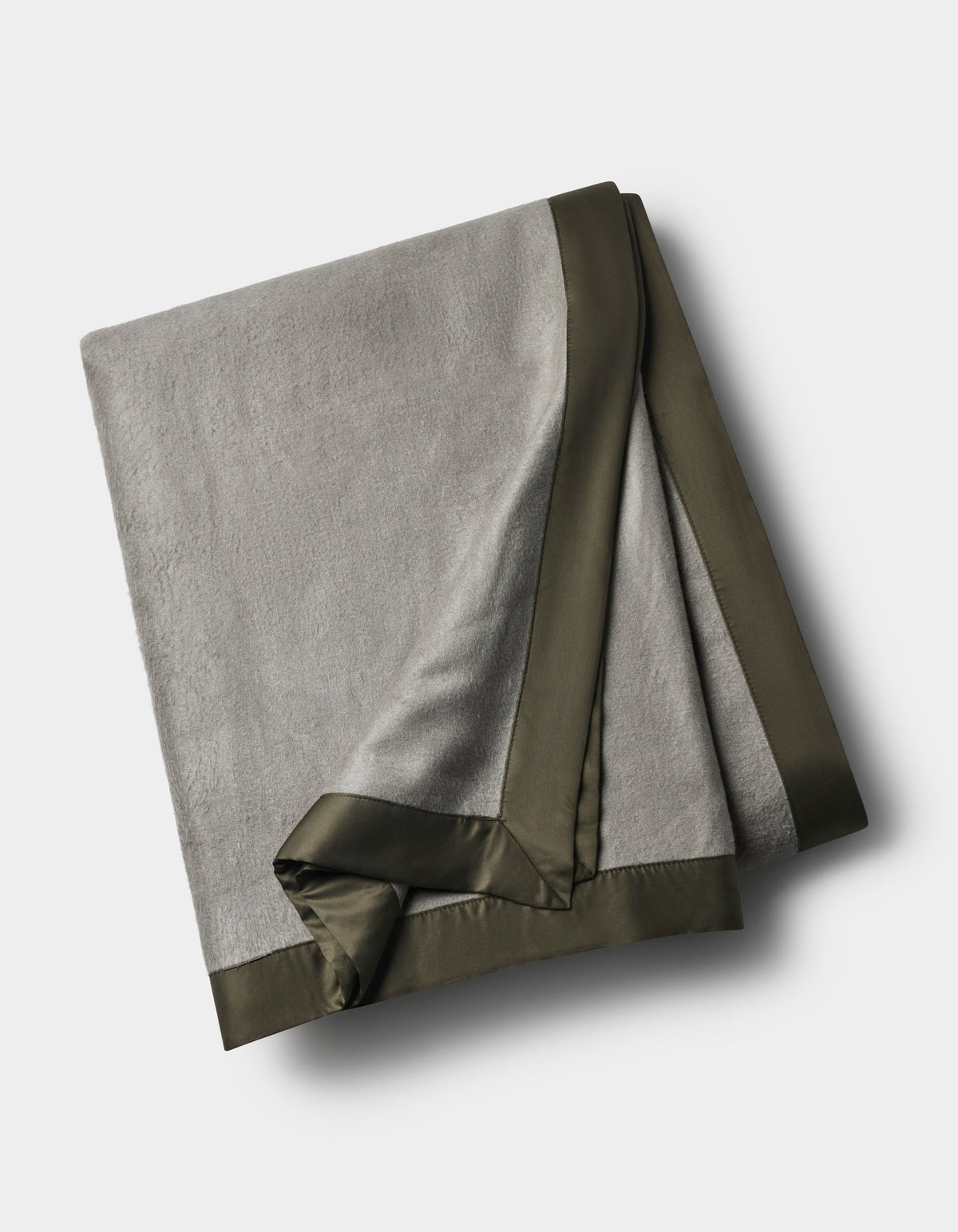 Gray Bamboo Blanket folded on a pale background, with a contrasting dark olive satin border and overlapping finished corners.