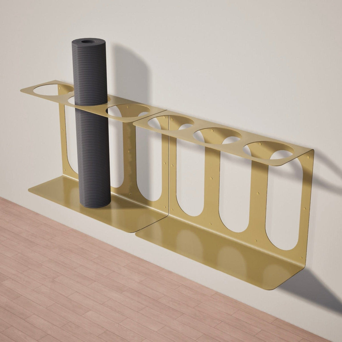 Angled view of the gold metal bracket holding one dark gray rolled mat or foam roller.