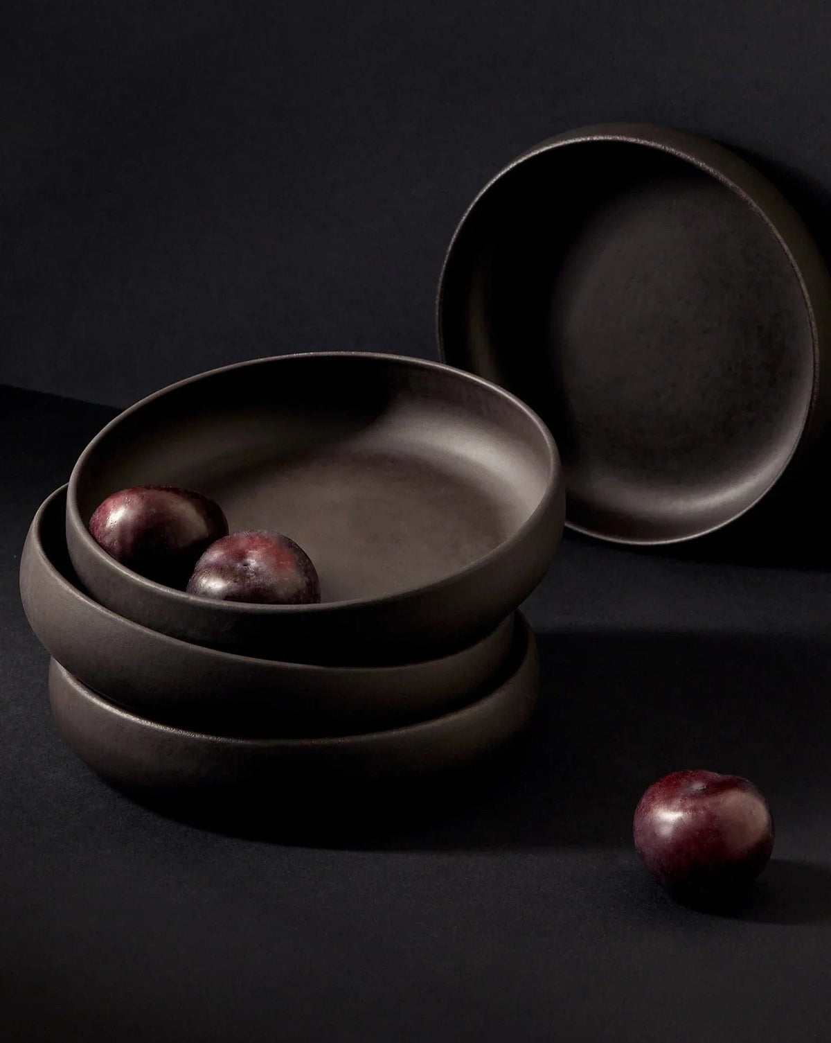 Gharyan Stoneware Japandi Tableware Pasta Bowl, Matte Black, styled with plums