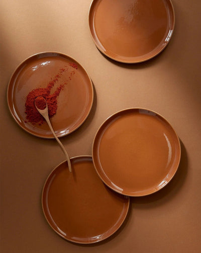 Stoneware side plates in Terracotta overhead view with wood spoon and chili powder
