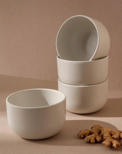 Stoneware bowls in Matte White stacked with ginger root on neutral background