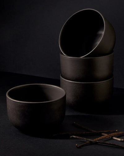 Stoneware bowls in Matte Black stacked with vanilla pods on dark background