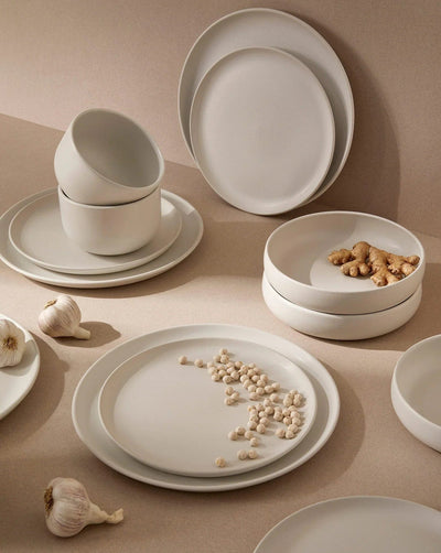 Stoneware bowl in Matte White styled overhead with dinnerware set