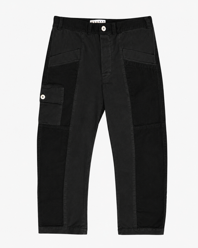 Front product view of black Trek pants with tonal utility panels and a buttoned cargo pocket.