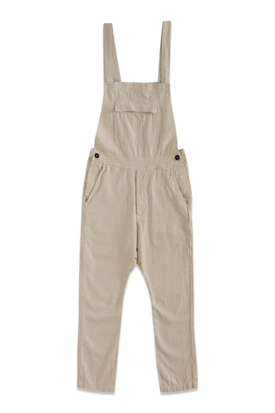 Front product view of cream overalls with adjustable straps, a bib pocket, and tapered legs.