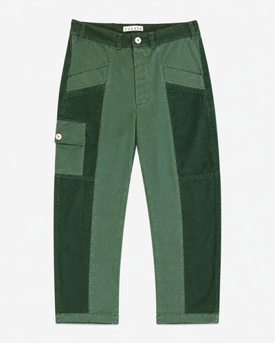 Front product view of green Trek pants with dark green utility panels and a buttoned cargo pocket.