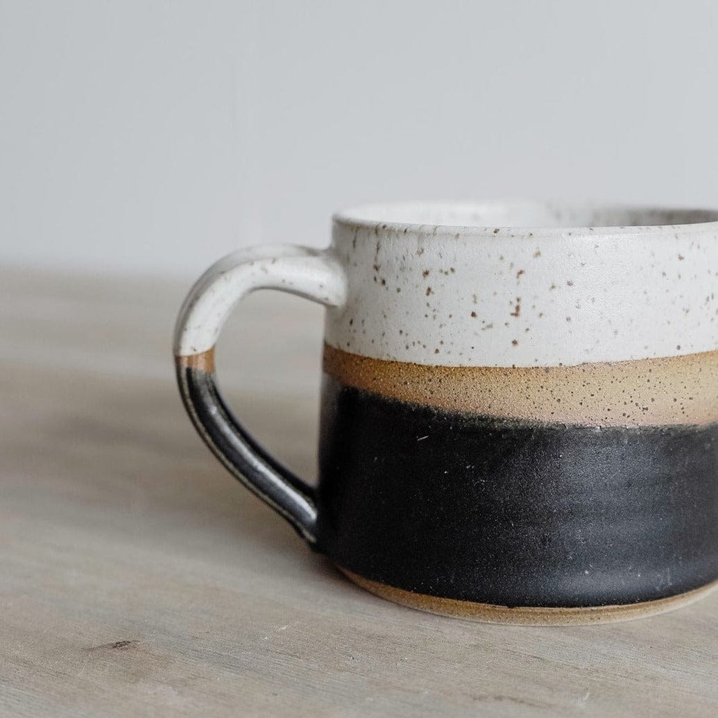 Handmade ceramic coffee mug with colorful glaze and speckled white interior by KJ Pottery