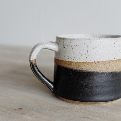 Handmade ceramic coffee mug with colorful glaze and speckled white interior by KJ Pottery