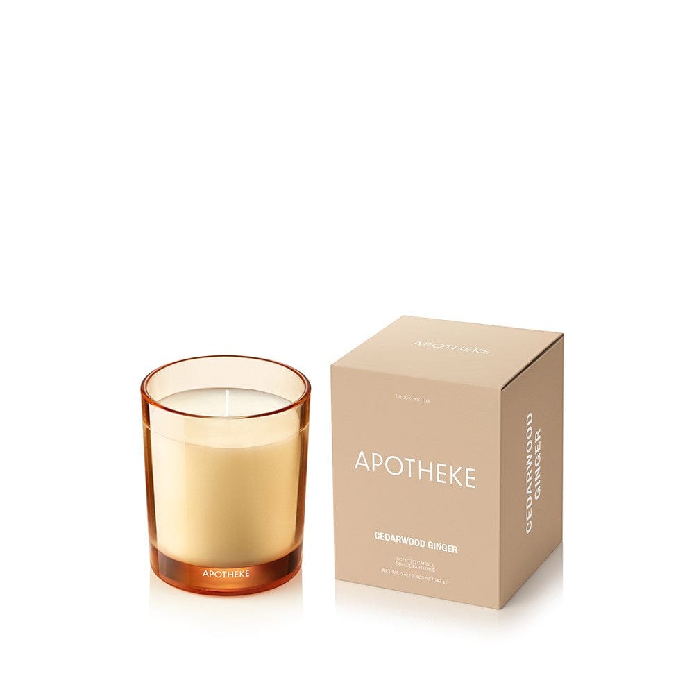 Cedarwood Ginger Petite Candle in amber sand-toned glass beside APOTHEKE packaging box