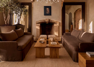 Luxurious living room with a chandelier, sofas, and a coffee table by House of Leon.