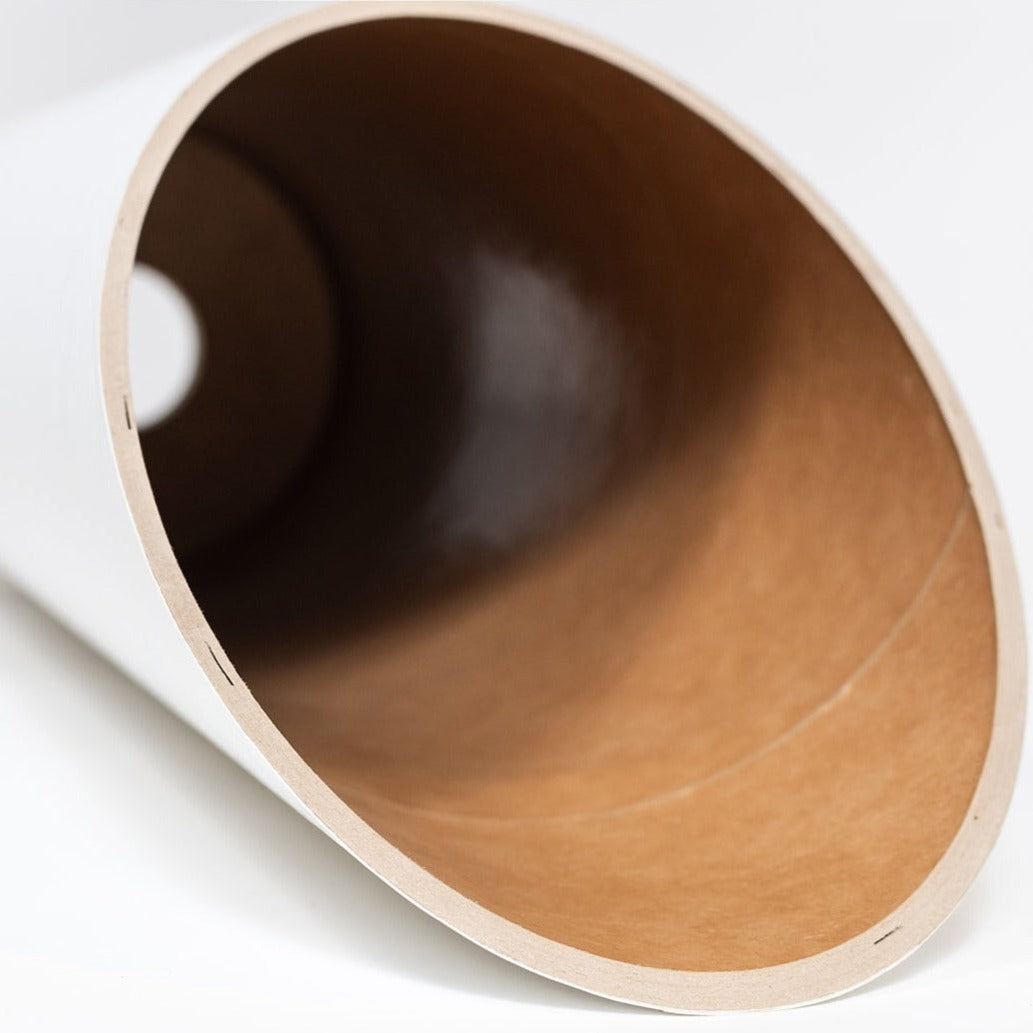 Interior view through the angled opening, showing the deep cylindrical cavity and brown paper construction.