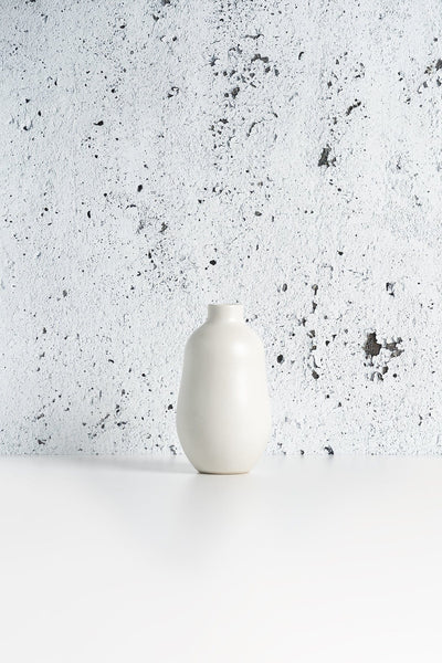 Stoneware vase in Matte White against textured concrete background