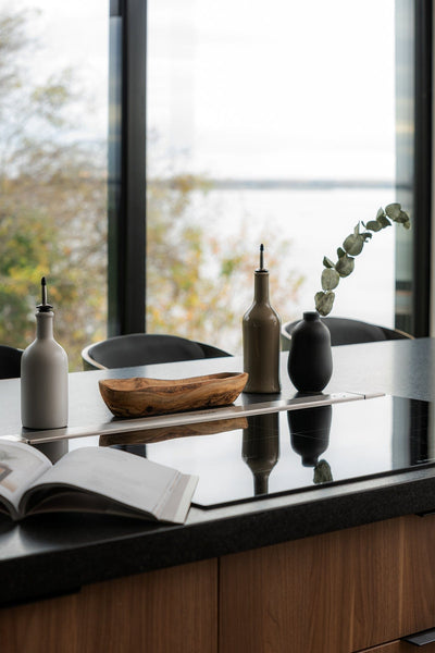 Stoneware vase in Matte Black styled on kitchen counter with bowl and accessories